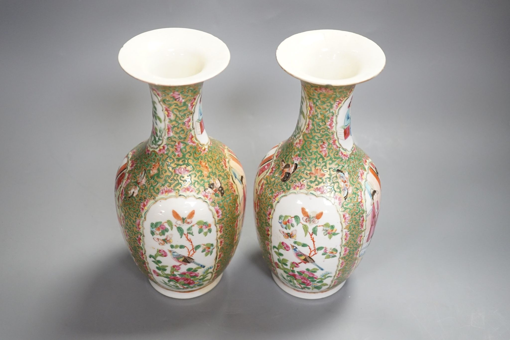 A pair of 19th century Chinese famille rose vases, 24 cms high.